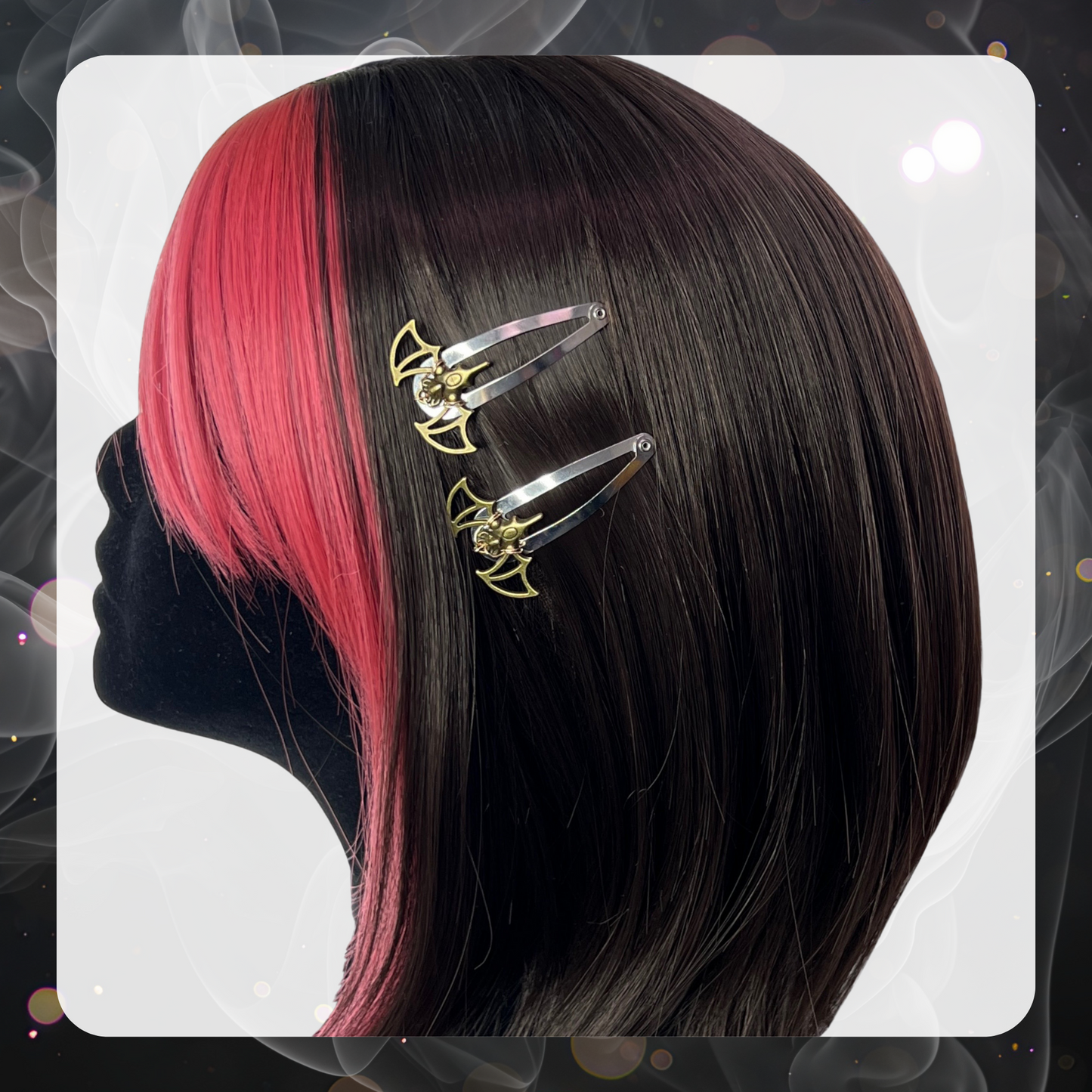 Pictures shows a black velvet mannequin head that has brown hair with the front bangs and sides being pink hair. The mannequin displays two bronze metal bat hair clips that use silver snap hair clips.