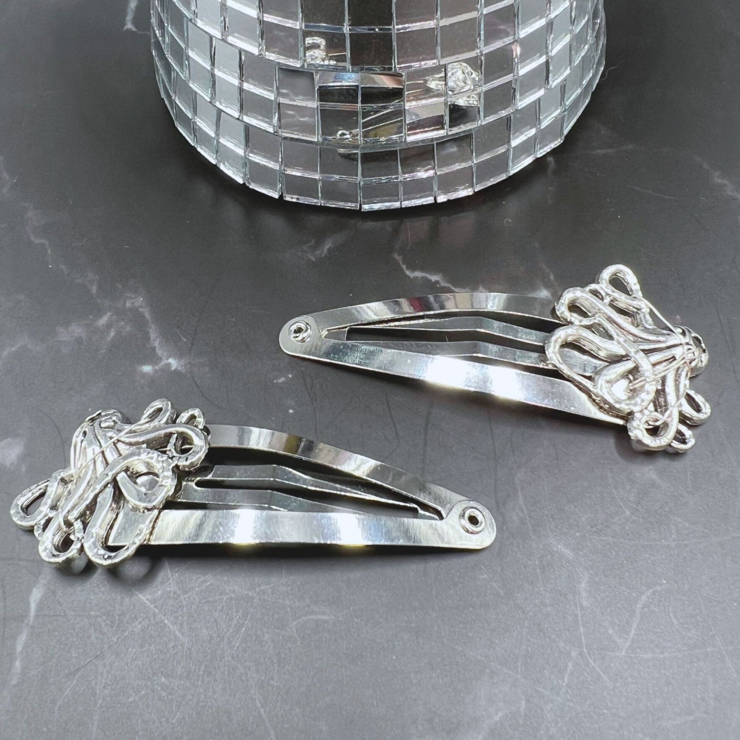 Gothic charm meets secure style with Octopus Tentacle Hair Clips. Displayed on a table.