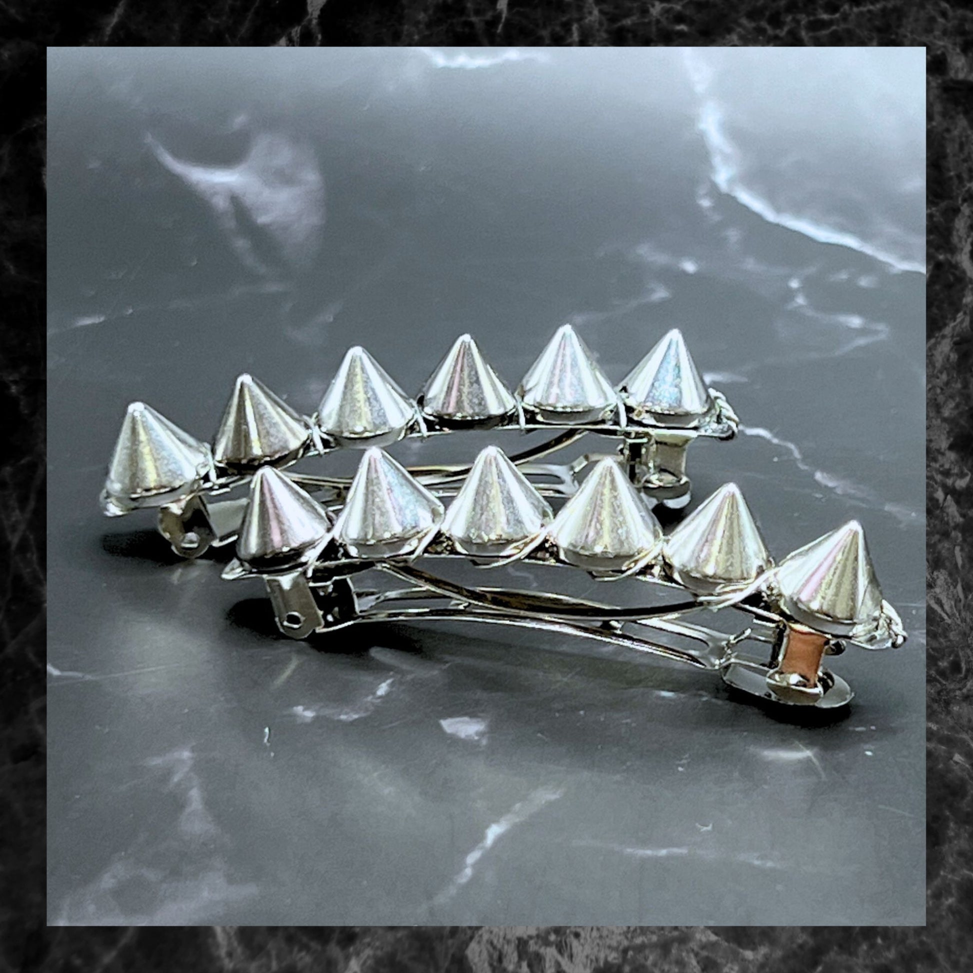 Edgy goth hair barrettes with silver, gunmetal, or gold spikes. Displayed on a table. Silver, 2.5".