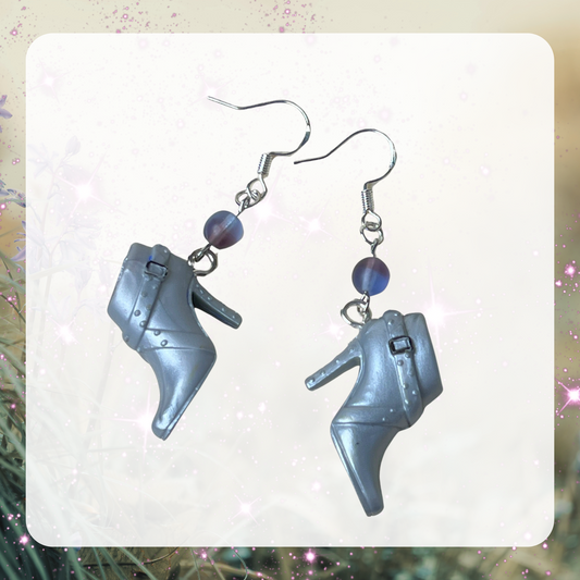 This is an image of a gray pair of Barbie heeled boots made into earrings with beads and silver ear hooks. 