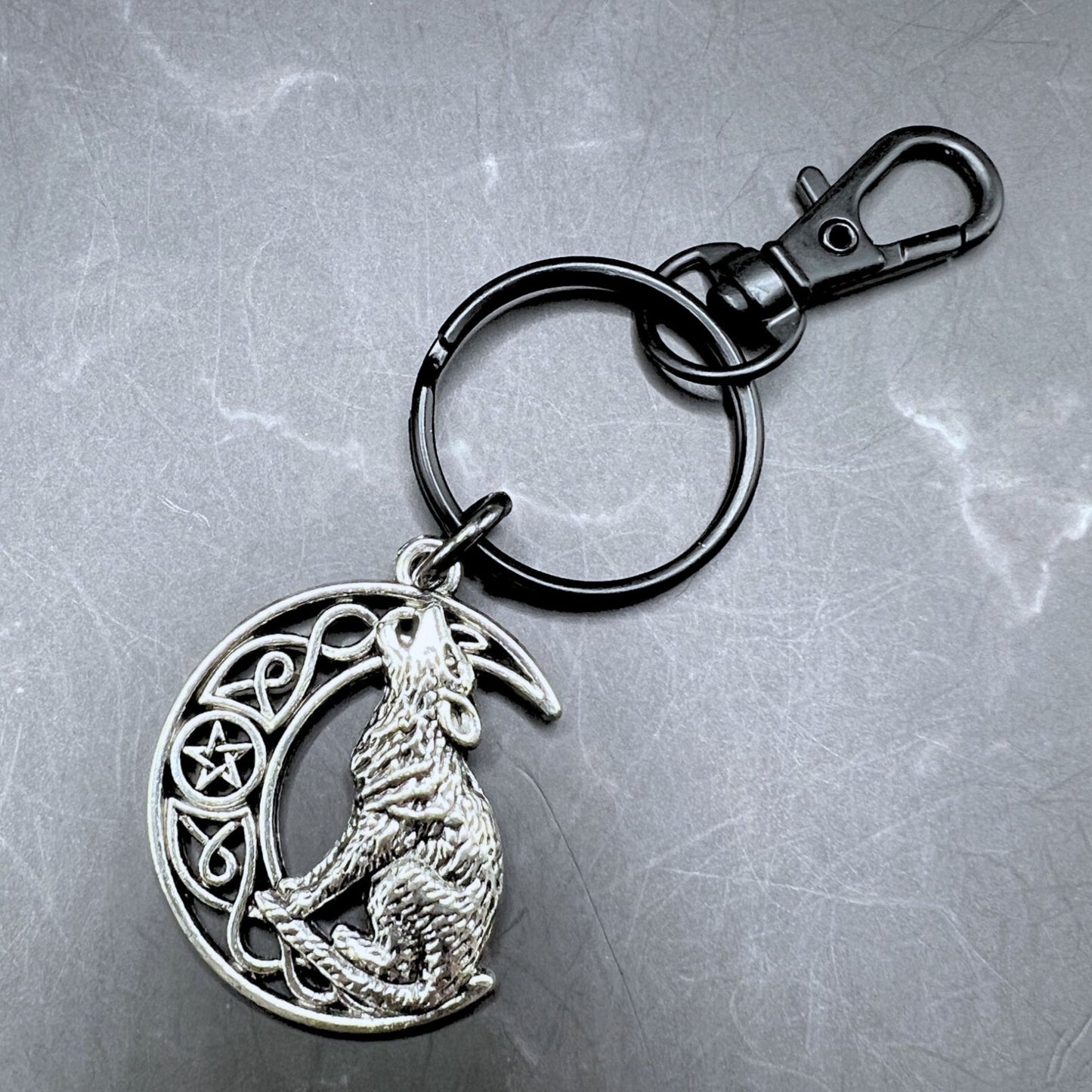 Detachable Celtic wolf howling at the moon keychain.