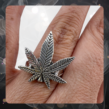 Picture shows as woman’s hand wearing a marijuana pot leaf silver tone metal ring.