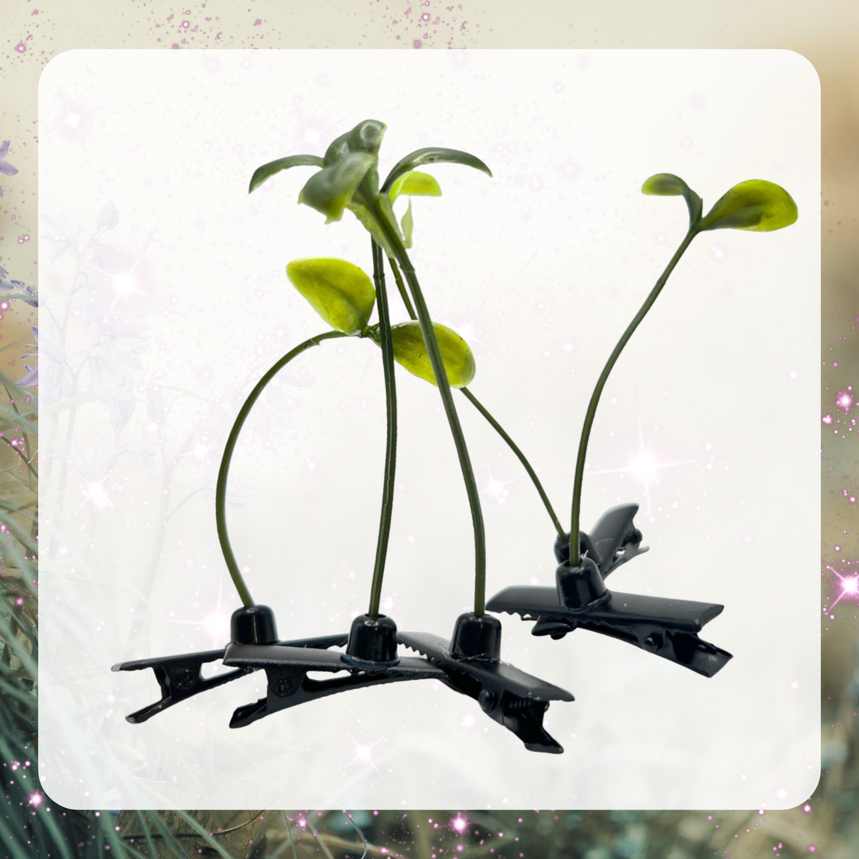 Picture shows five bean sprout hair clips. Each clip has a black alligator clip and a green plant with two leaves. 