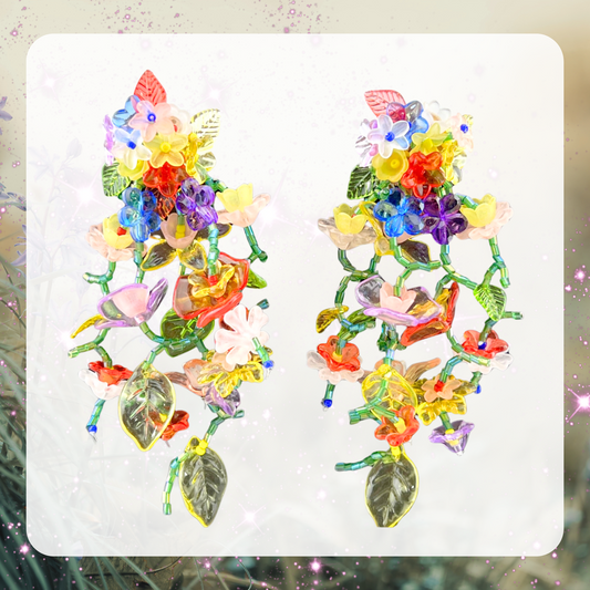 This is an image of some extravagant floral earrings. They are a waterfall chandelier style with beaded leaves and flowers all falling down in a beautiful vine like structure. 