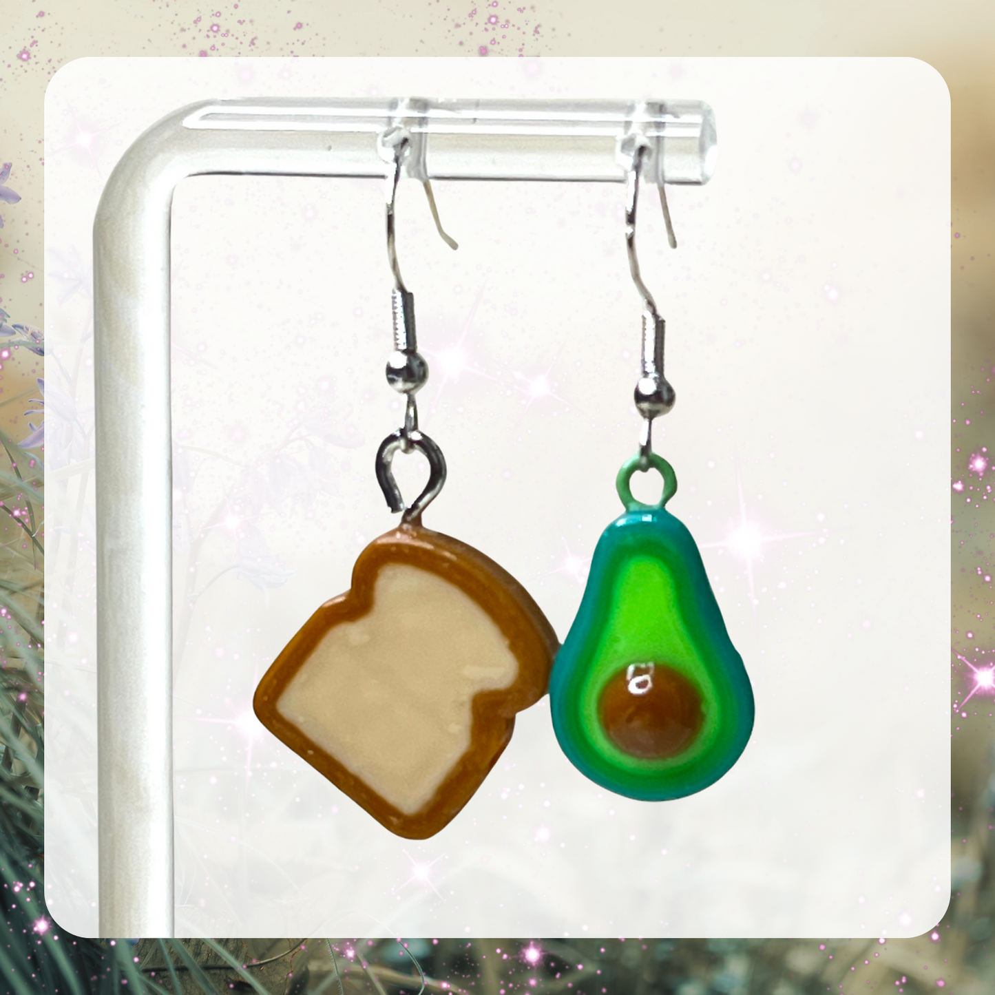 Picture shows mini 3D printed bread and sliced in half avocado dangle earrings. 