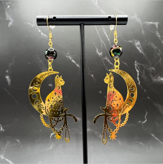 Close-up of Bohemian Beaded Cat Earrings featuring gold cat charms and black glass beads.