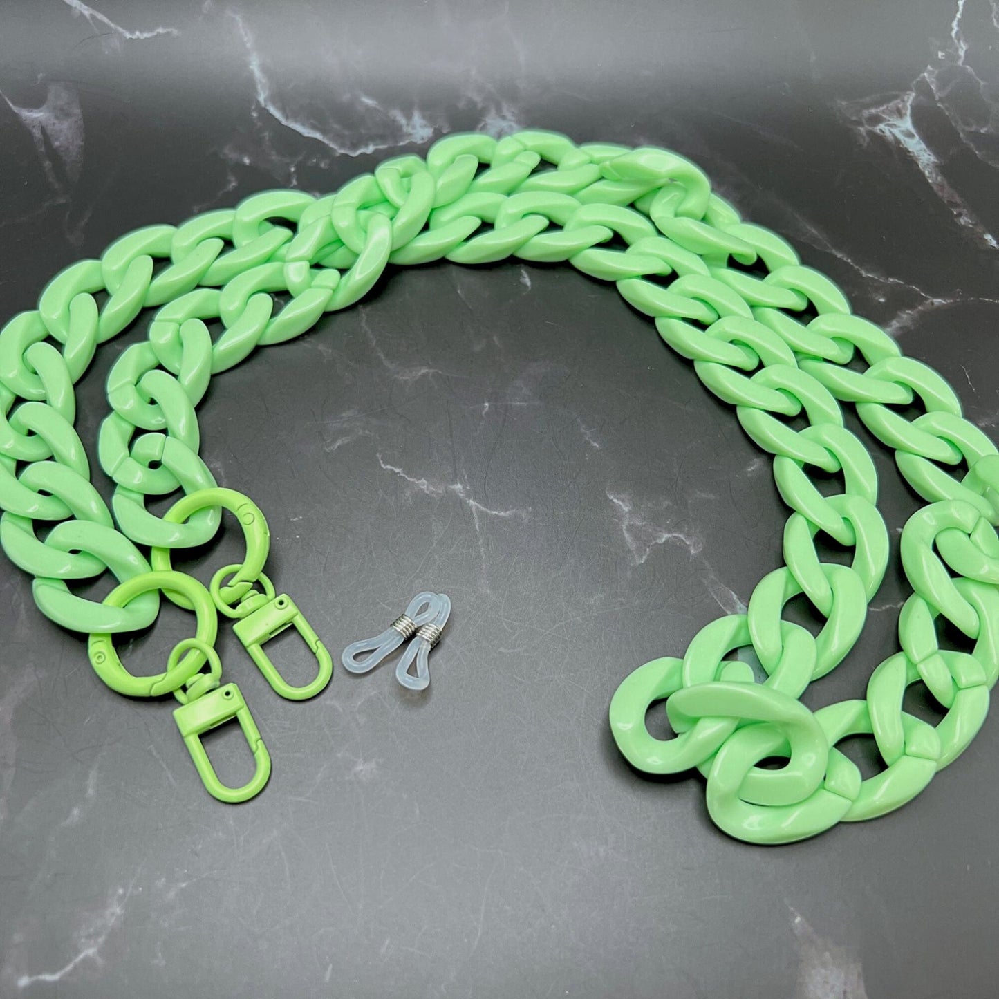 Versatile Green Chunky Chain Link Lanyard for glasses, keys, badges, or masks. Displayed on a table.
