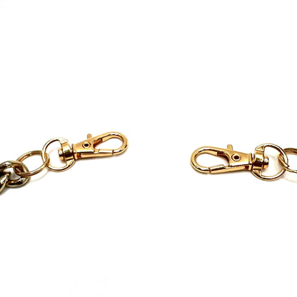 Vintage-inspired Pearl Pants Chain, a versatile accessory for jeans or bags. Shows a close-up of the gold swivel clasps.