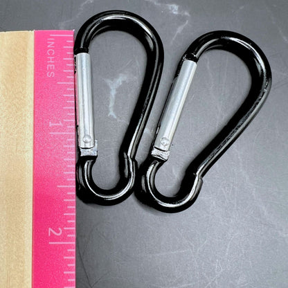 Black carabiner clips displayed next to a ruler showing the length as 1.5".