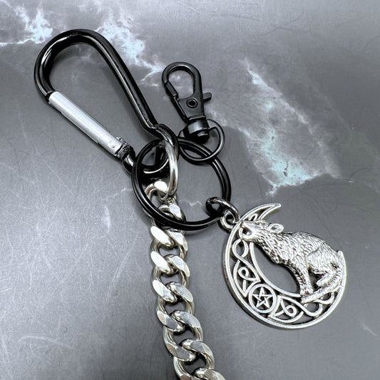 Durable stainless steel wallet chain with customizable clips and wolf keychain. Displayed on a table. Close up of the wolf keychain.