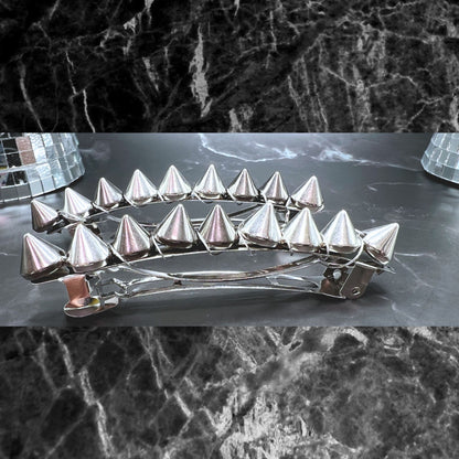 Edgy goth hair barrettes with silver, gunmetal, or gold spikes. Displayed on a table. 3" silver clips.