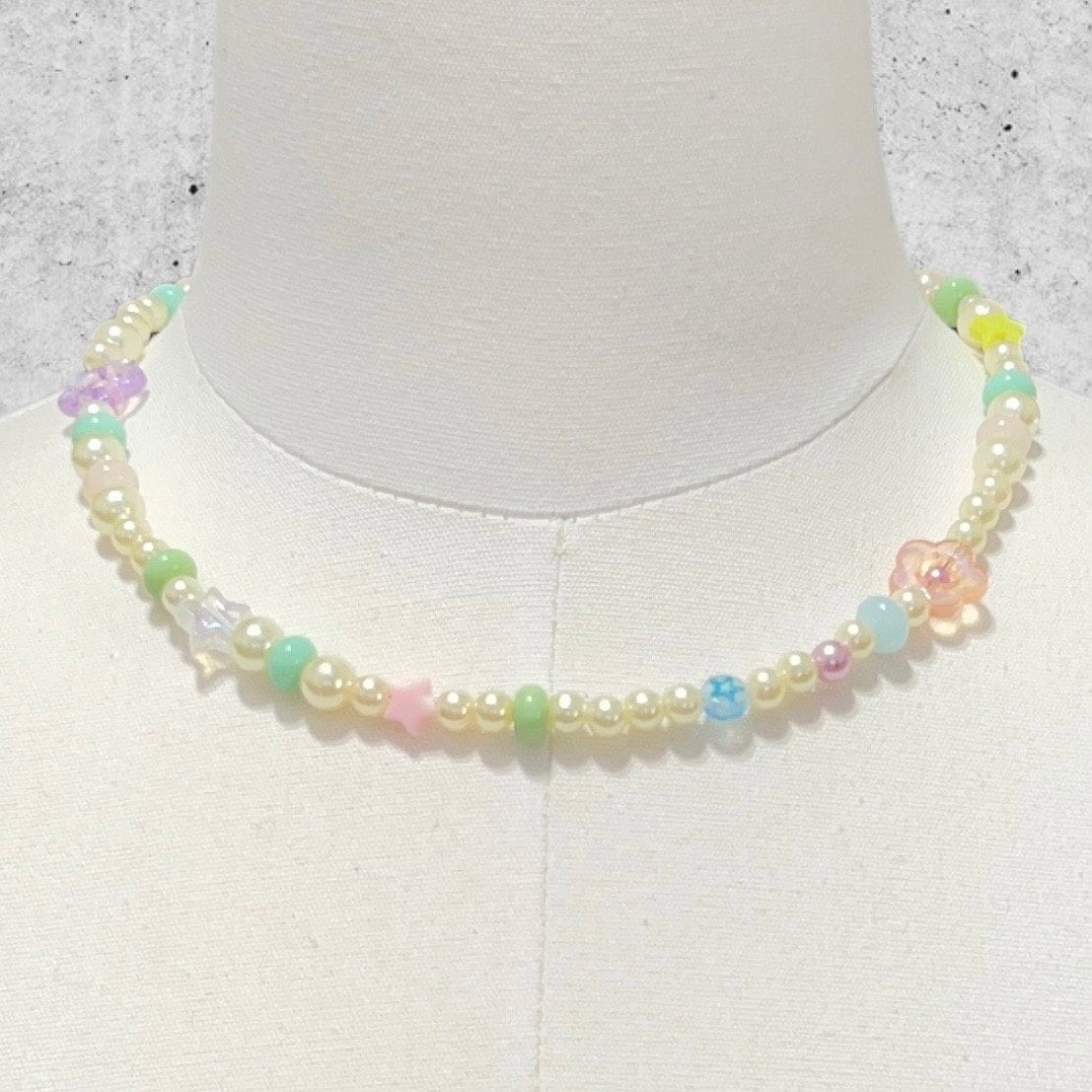 Handmade Pearls and Pastel Beaded Choker Necklace by Extra Kitsch. Stars and butterflies displayed on a mannequin.