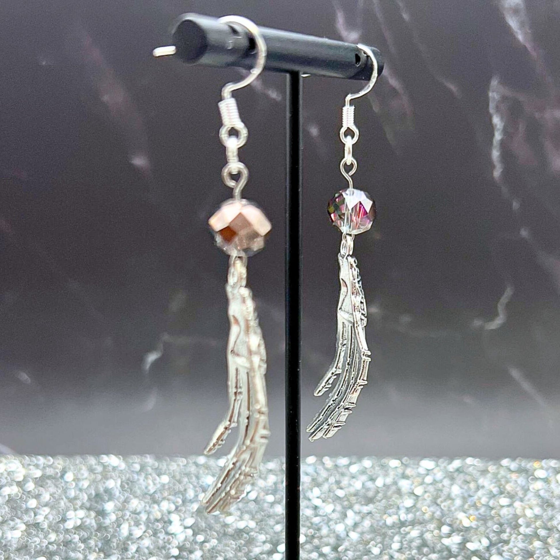 Skeleton Hand Beaded Earrings. Displayed on a clear stand.