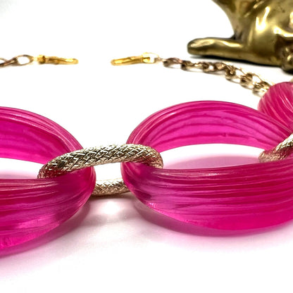 Close-up of Pink Wallet Chain – versatile vintage upcycled jewelry. Displays a close-up of the pink chunky plastic chain links with the gold links.