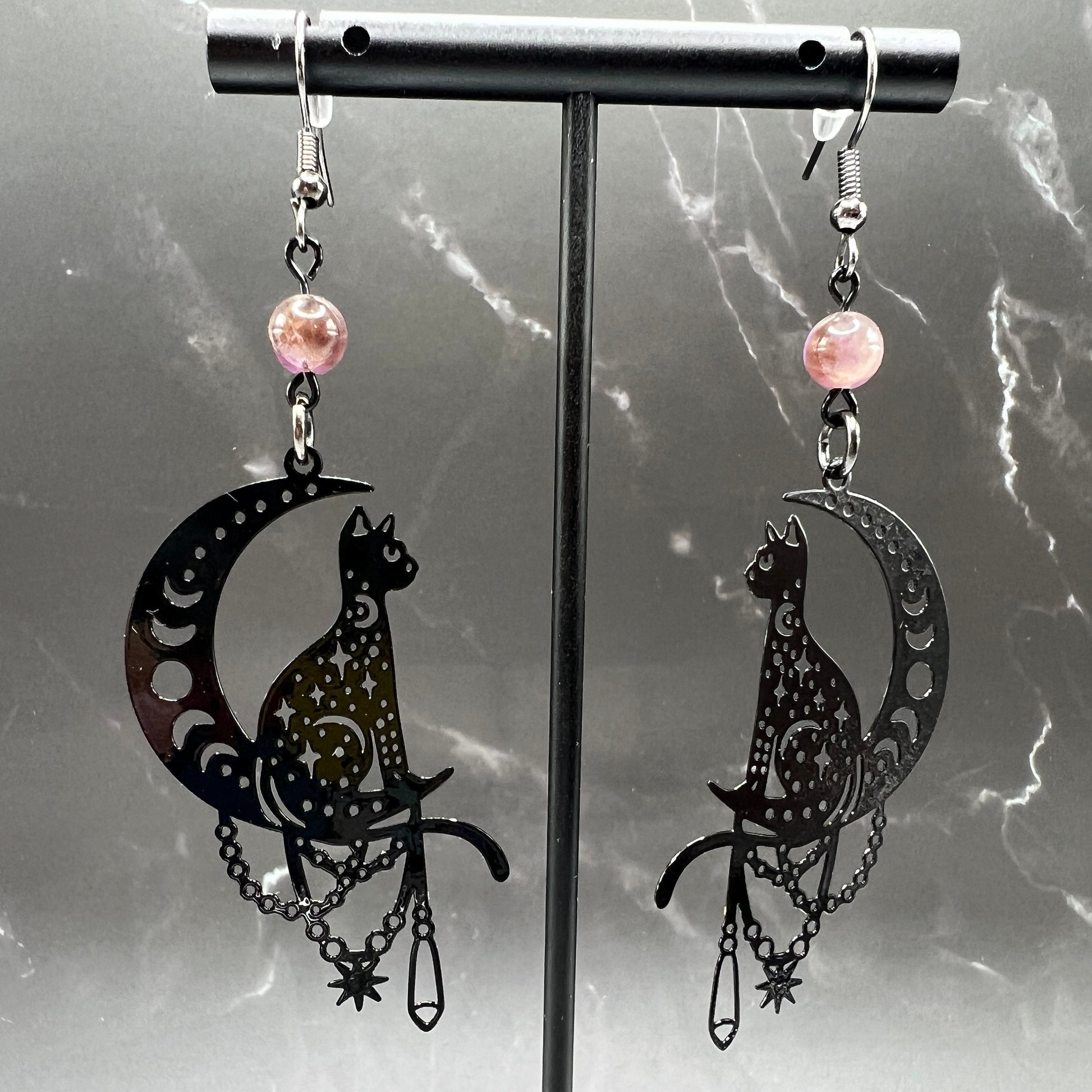 Close-up of Bohemian Beaded Cat Earrings featuring black cat charms and purple crystal beads.