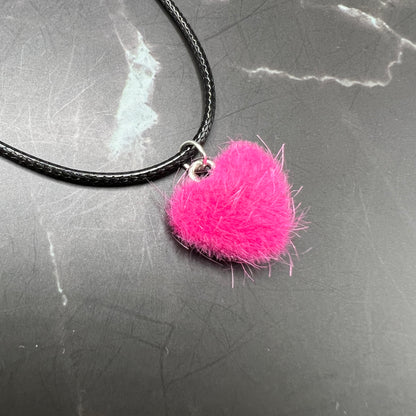 Close-up of Hot Pink Fuzzy Teddy Bear Heart Necklace in warm hues. Cozy teddy bear fur pendant on adjustable Y2K nylon cord. Perfect for Valentine's and special occasions