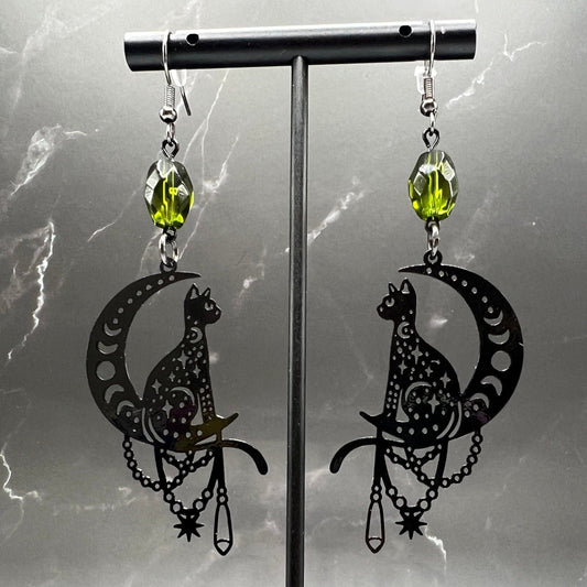Close-up of Bohemian Beaded Cat Earrings featuring black cat charms and green beads.